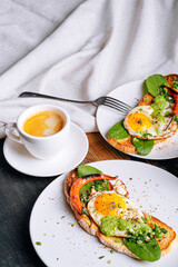 hearty and high-calorie breakfast. delicious and mouth-watering bruschetta with fried eggs and herbs for breakfast with a cup of aromatic coffee.