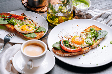 hearty and high-calorie breakfast. delicious and mouth-watering bruschetta with fried eggs and herbs for breakfast with a cup of aromatic coffee.