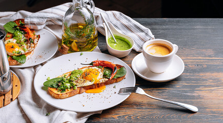 hearty and high-calorie breakfast. delicious and mouth-watering bruschetta with fried eggs and herbs for breakfast with a cup of aromatic coffee.