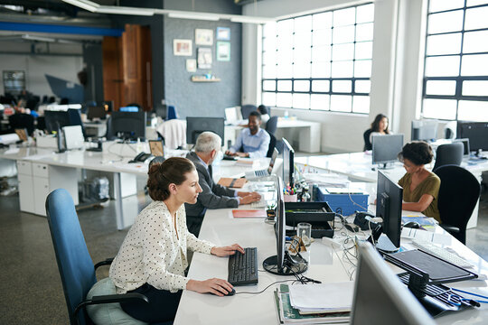 Everyones one hundred percent focused in this office. Shot of colleagues working on their computers while sitting in an office.