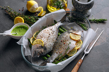 raw baked dorado fish with asparagus and lemon in spices