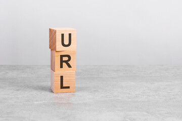 wooden cube on a table with text URL. copy space on right for design, gray background