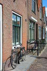 Fototapeta na wymiar Typical Dutch street - bicycles are on a house facade