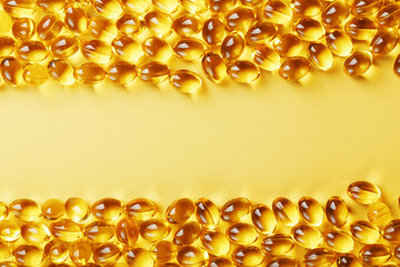 Capsules in a shell with liquid vitamin D3 on a yellow background and a place for text