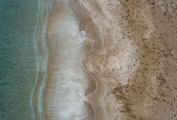 Aerial view drone of empty tropical sandy beach with golden sand. Seascape background