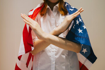 teenage girl generation Z with her arms crossed at her chest and USA American flag demonstrates...