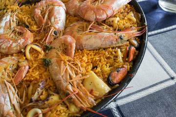 typical Spanish seafood paella in a pan
