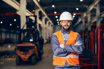 Portrait of a heavy industry metal factory worker in facility. - obrazy, fototapety, plakaty