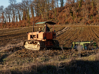 Agriculture,tractor preparing land with seedbed cultivator as part of pre seeding activities in early spring season of agricultural works at farmlands.