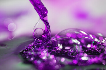 Close-up of abstract, purple water splash, drops on a blurred background