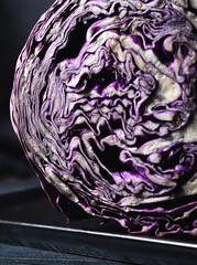 Obraz premium detail of a purple cabbage cut in half with low key illumination, selective focus