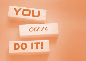 YOU CAN DO IT word on wooden blocks on gray background. Motivation affirmation encouraging words...