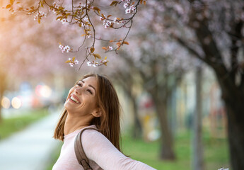Portrait of a smiling girl enjoys a beautiful spring morning.