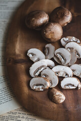 Organic Cremini Mushrooms Sliced and Whole on a Wooden Cutting Board