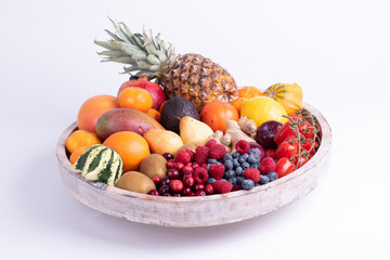 fresh vegetables and fruits isolated on a white background in wooden tray.