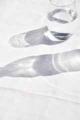 glass of water with reflection on white background