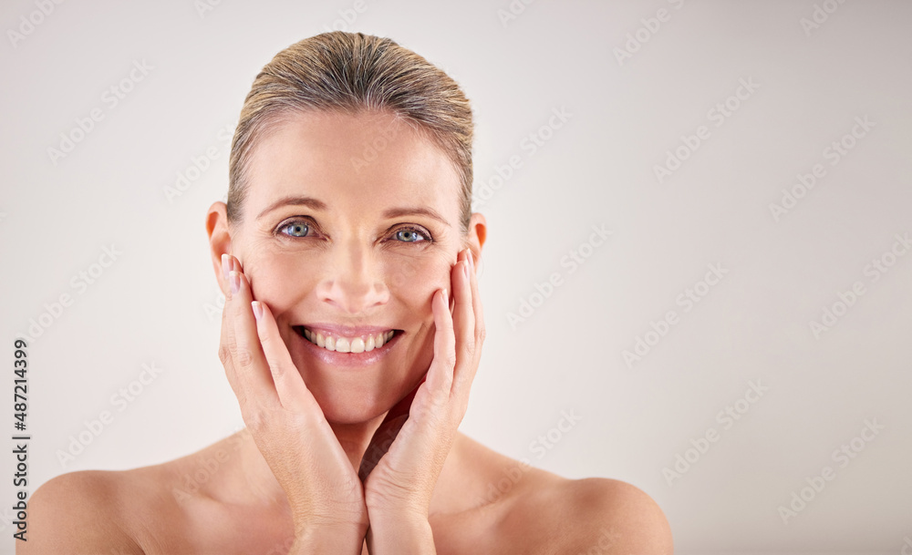 Poster My skin still feels great. Cropped studio portrait of an attractive mature woman touching her skin.