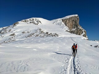 Naklejka na ściany i meble Skitour on the mountain Mutteristock, Innerthal. Ski mountaineering in Switzerland.Winter landscape panorama in the alps. Skimo