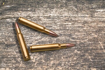gun bullets on wooden surface background