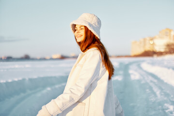 young woman in a white coat in a hat winter landscape walk travel