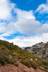 Fototapeta na wymiar A landscape photo of mountains and its rocks. Cloudy weather and green plants. Hiking and trekking route. Lycian way.