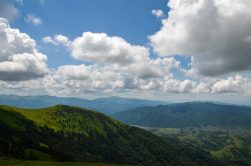 Fototapeta na wymiar Aerial view from mountain range of rural landscape of the Carpathian Mountains with village in the valley