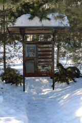 Old metal rusty mailbox in the forest in snow