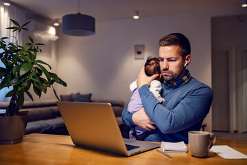 A super-dad having conference call with colleagues while sitting at home with his baby.