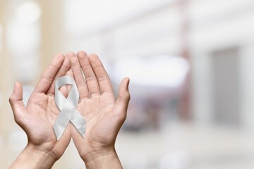 White January, mental health awareness campaign. Person holding a ribbon.