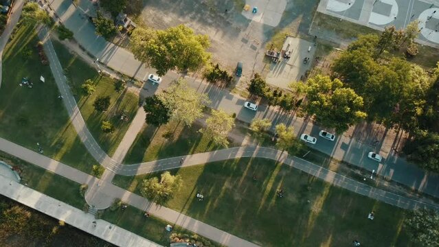 Sunset over Park, cars, people and trees Fly aerial Drone 4k - Argentina Buenos Aires Zarate