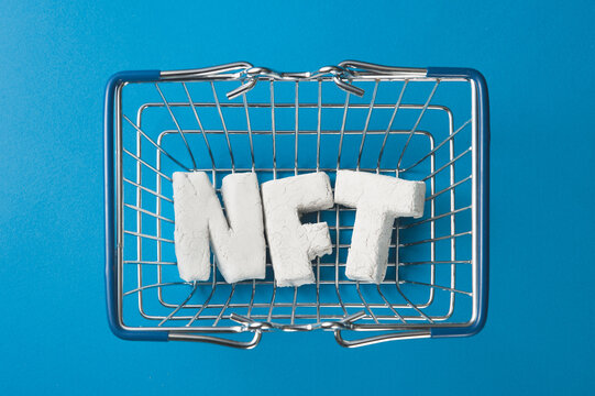 How to buy nft token. The concept of buying an NFT token in a shopping cart.