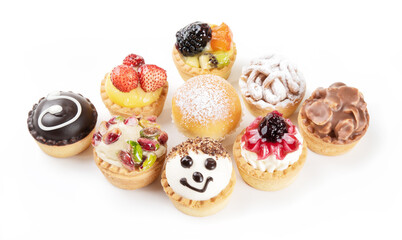 Mignon pastry, assortment of small desserts with berries, chocolate, pistachios, cream and whipped...