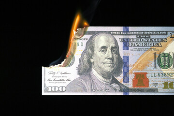 Close up shot of a 100 dollar banknote burning