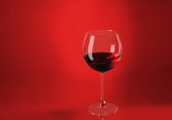 Red wine glass over colored background on the desk