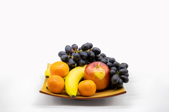 Bamboo plate filled with fresh fruit in this Still Life image