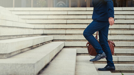 Climbing the steps to success. Profile shot of an unidentifiable businessman walking to work in the city.