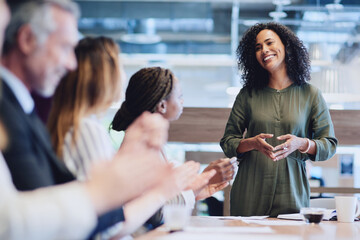 I couldnt have done it without all of you. Cropped shot of a group of businesspeople applauding a colleague while sitting in the boardroom during a meeting.