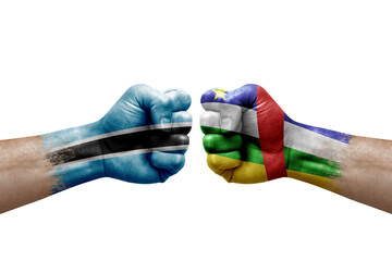 Two hands punch to each others on white background. Country flags painted fists, conflict crisis concept between botswana and central african republic