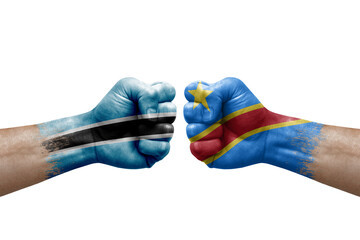 Two hands punch to each others on white background. Country flags painted fists, conflict crisis concept between botswana and dr congo