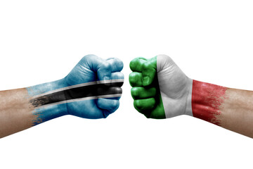 Two hands punch to each others on white background. Country flags painted fists, conflict crisis concept between botswana and italy