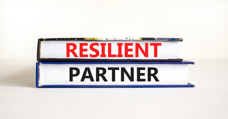 Resilient partner symbol. Concept words Resilient partner on books on a beautiful white table white background. Business resilience and resilient partner concept, copy space.