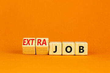 Extra job symbol. Turned wooden cubes and changed concept words Job to Extra job. Beautiful orange...