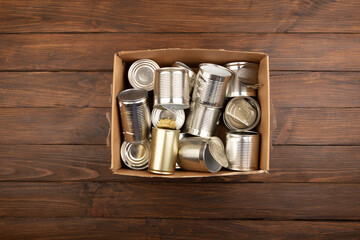 Recycling and ecology concept. Sorting household waste captured from above, flat lay. Wooden background