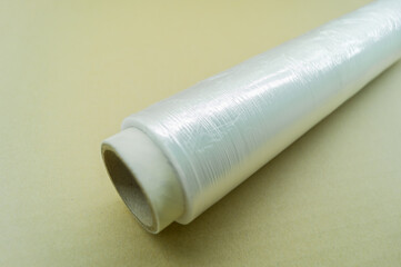 Roll of food stretch film for food packaging. Packaging film in a roll on a cardboard spool. Selective focus