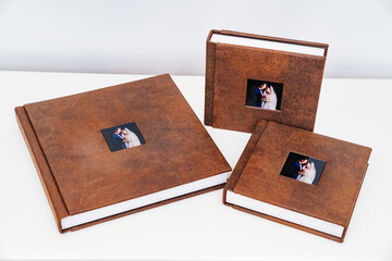 wedding photobooks in brown leather binding with photos on the cover