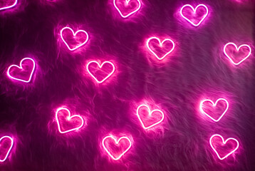 Neon pink heart on white fur. Valentine's day background - 487224124