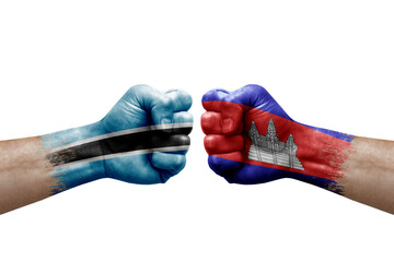 Two hands punch to each others on white background. Country flags painted fists, conflict crisis concept between botswana and cambodia