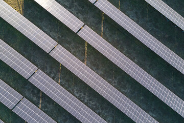 Aerial view of large sustainable electrical power plant with rows of solar photovoltaic panels for producing clean ecological electric energy. Renewable electricity with zero emission concept