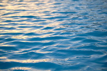 Closeup seascape surface of blue sea water with small ripple waves