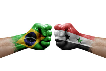 Two hands punch to each others on white background. Country flags painted fists, conflict crisis concept between brazil and syria